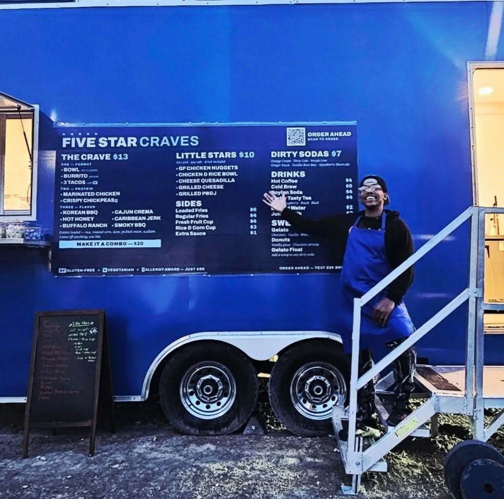 Five Star Craves food truck and owner standing at the service window